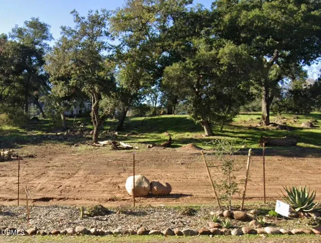 a backyard of a house with a yard and outdoor seating