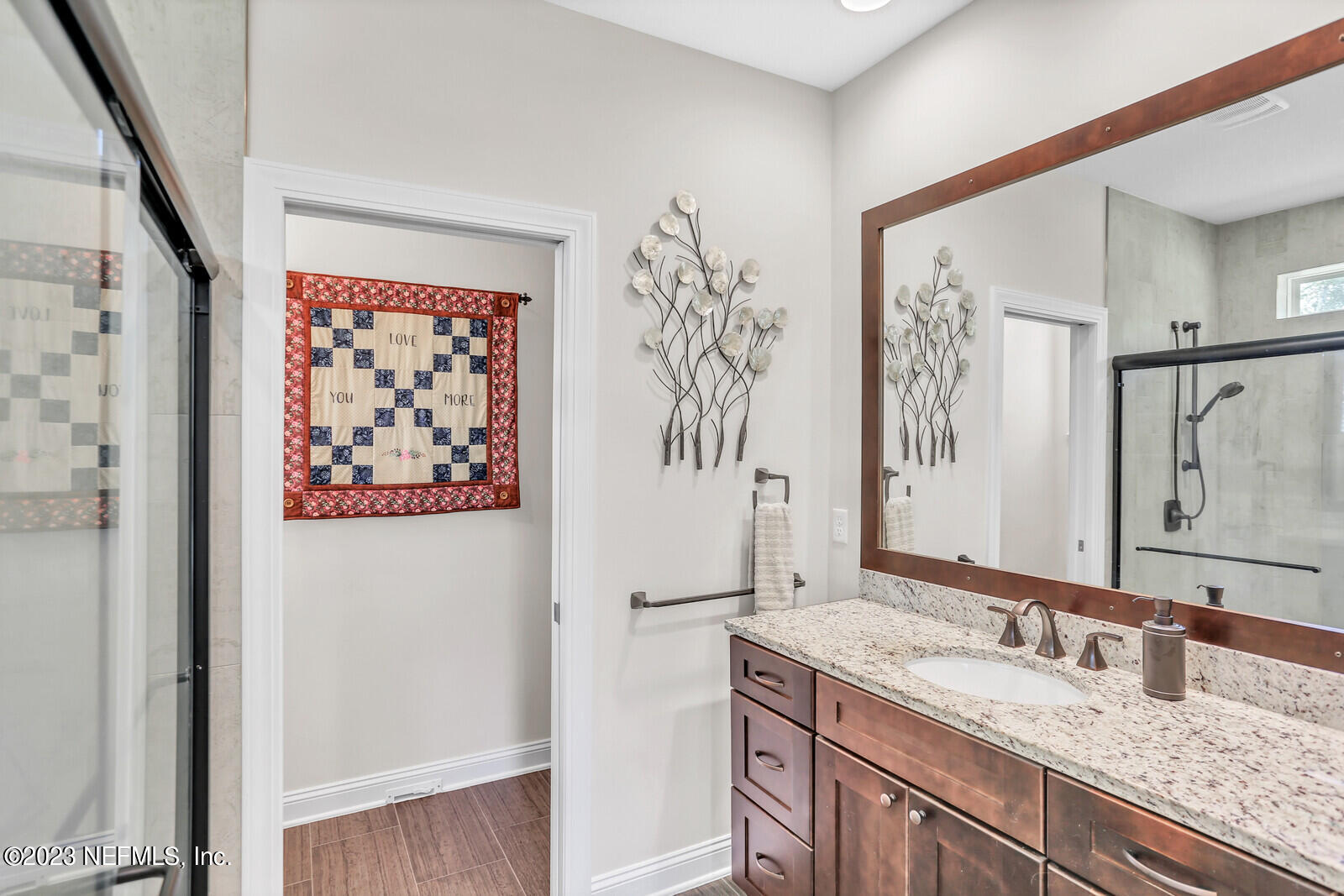 1521 Lee Road St. Johns, FL 32259 - Photo 15 of 38 a bathroom with a granite countertop sink a mirror and a shower