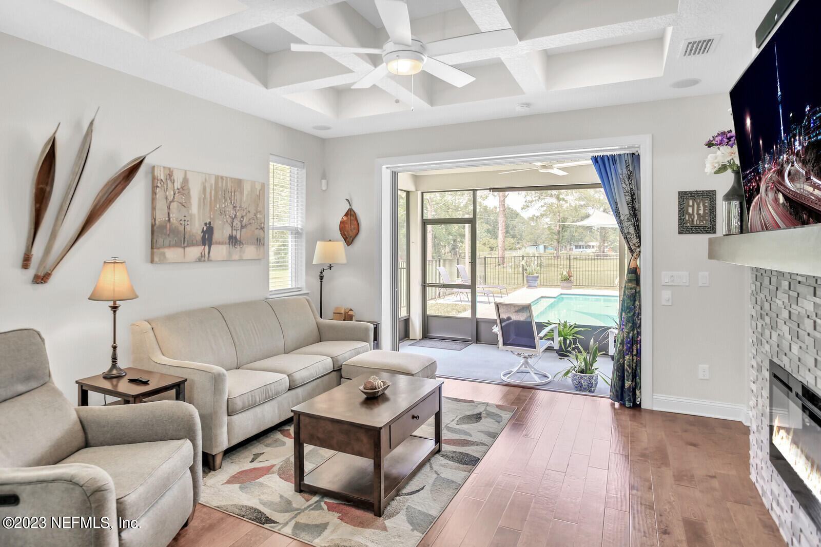 1521 Lee Road St. Johns, FL 32259 - Photo 22 of 38 a living room with furniture a flat screen tv and a large window