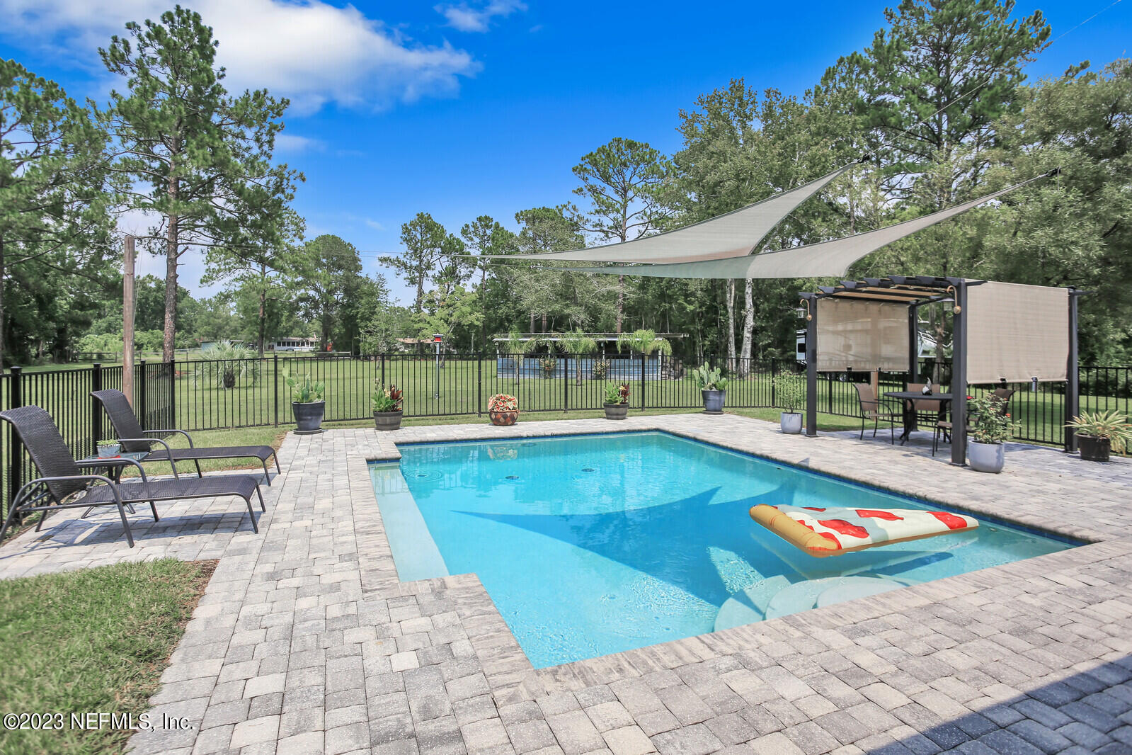 1521 Lee Road St. Johns, FL 32259 - Photo 25 of 38 a view of a swimming pool with a patio and a yard