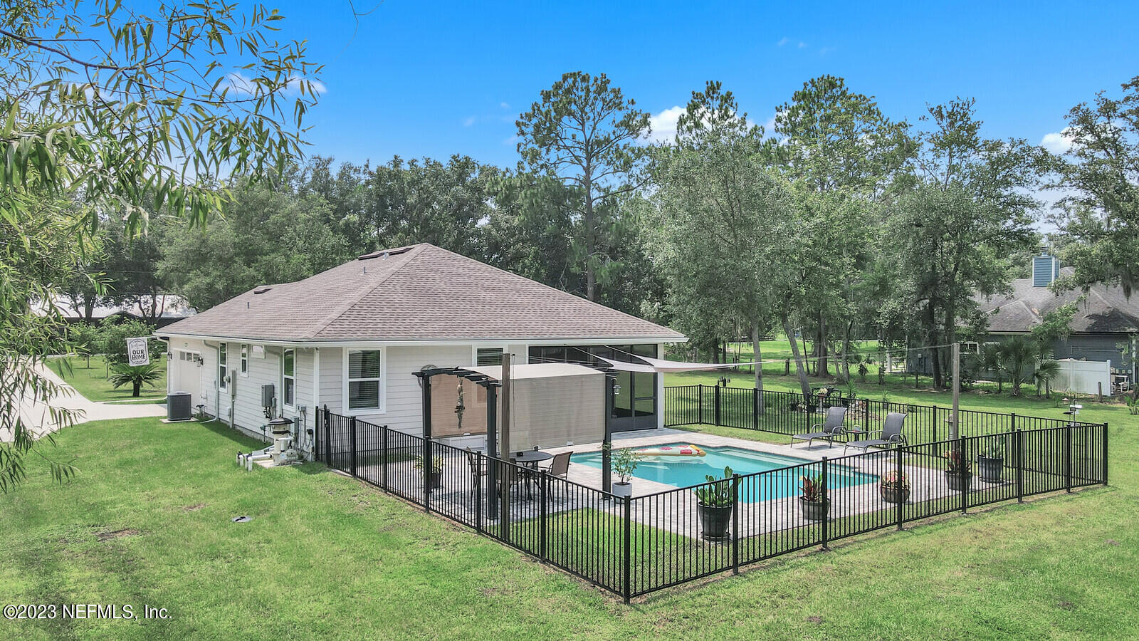 1521 Lee Road St. Johns, FL 32259 - Photo 27 of 38 a yellow house with a yard and sitting area