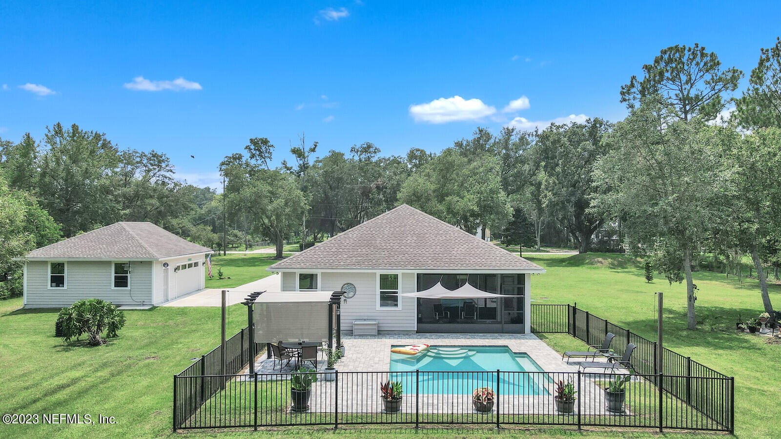 1521 Lee Road St. Johns, FL 32259 - Photo 28 of 38 a view of a white house with a big yard and potted plants