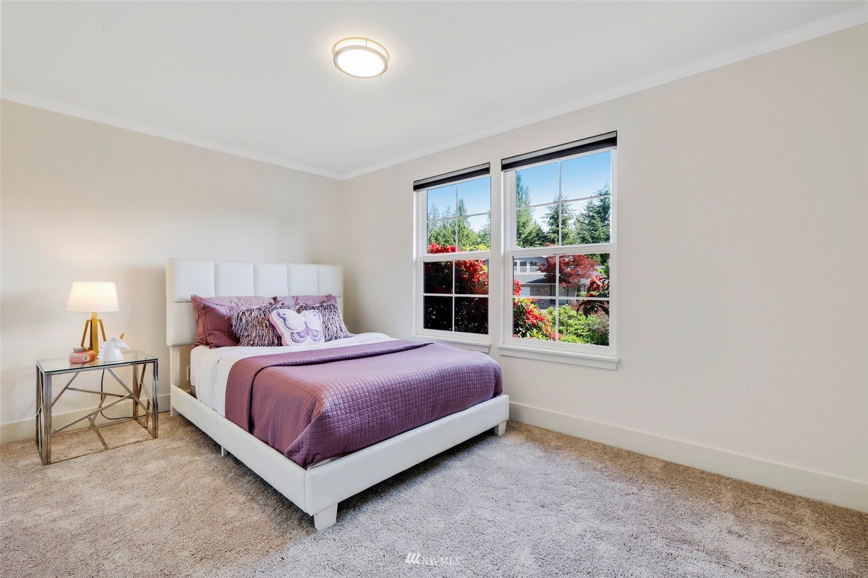1808 243rd Place Southeast Bothell, WA 98021 - Photo 16 of 32 a spacious bedroom with a bed lamp and window