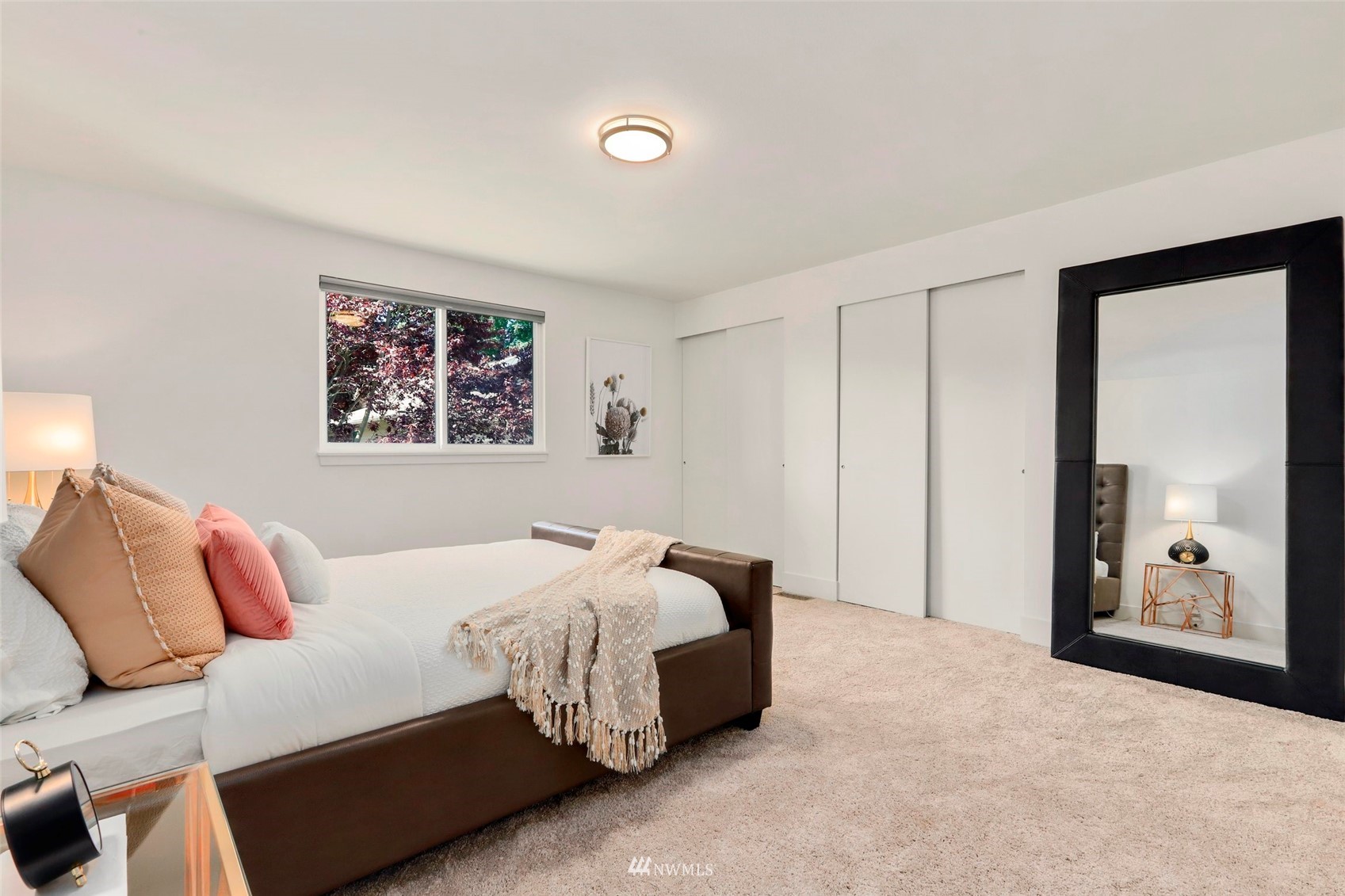 1808 243rd Place Southeast Bothell, WA 98021 - Photo 19 of 32 a bedroom with a large bed and a painting on the wall