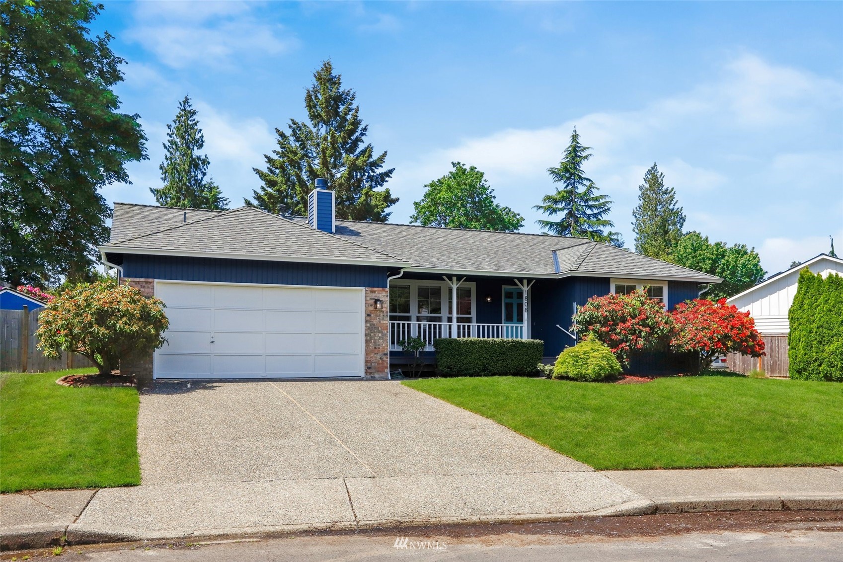 1808 243rd Place Southeast Bothell, WA 98021 - Photo 2 of 32 a front view of a house with a garden and plants
