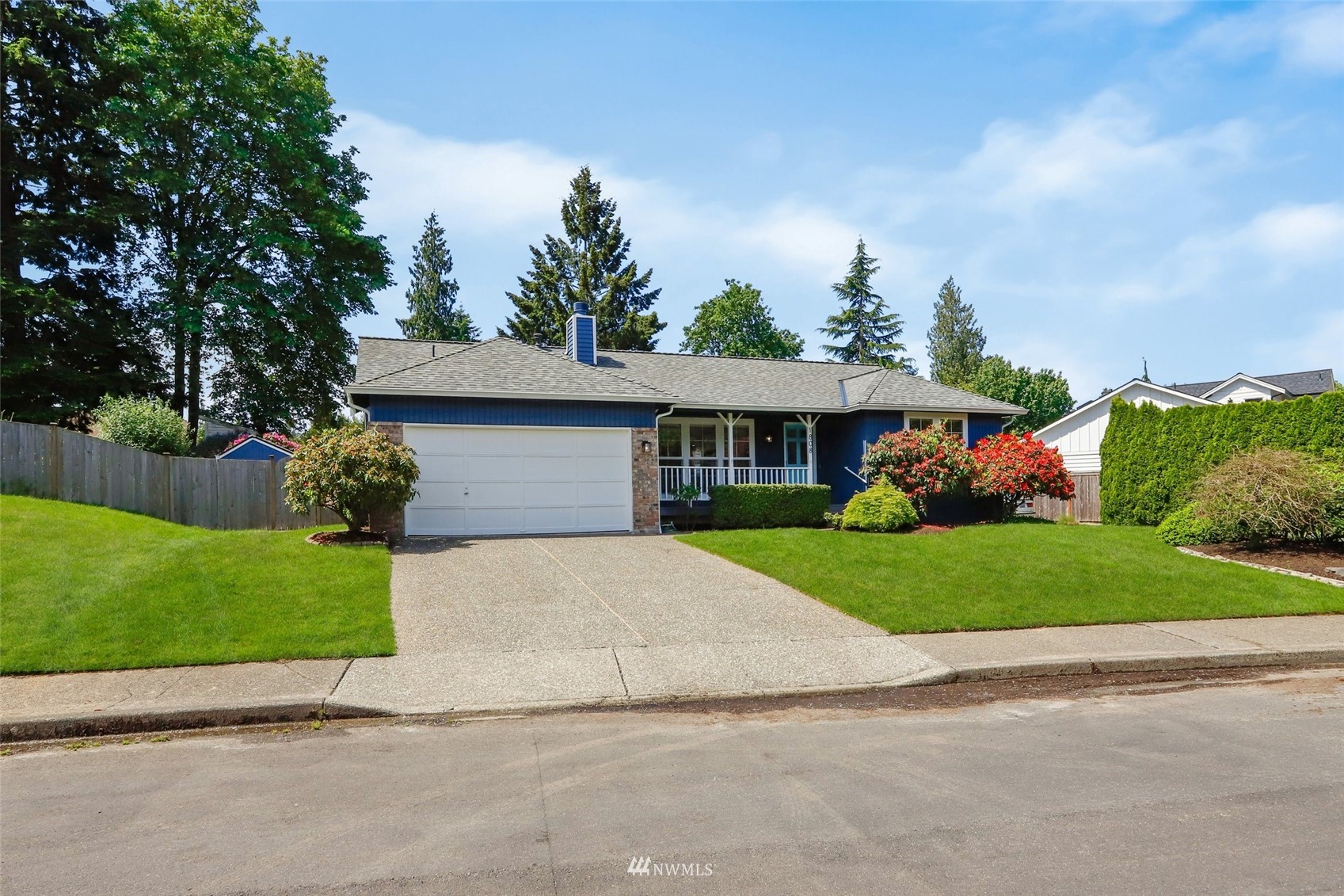 1808 243rd Place Southeast Bothell, WA 98021 - Photo 30 of 32 a front view of a house with a yard and garage