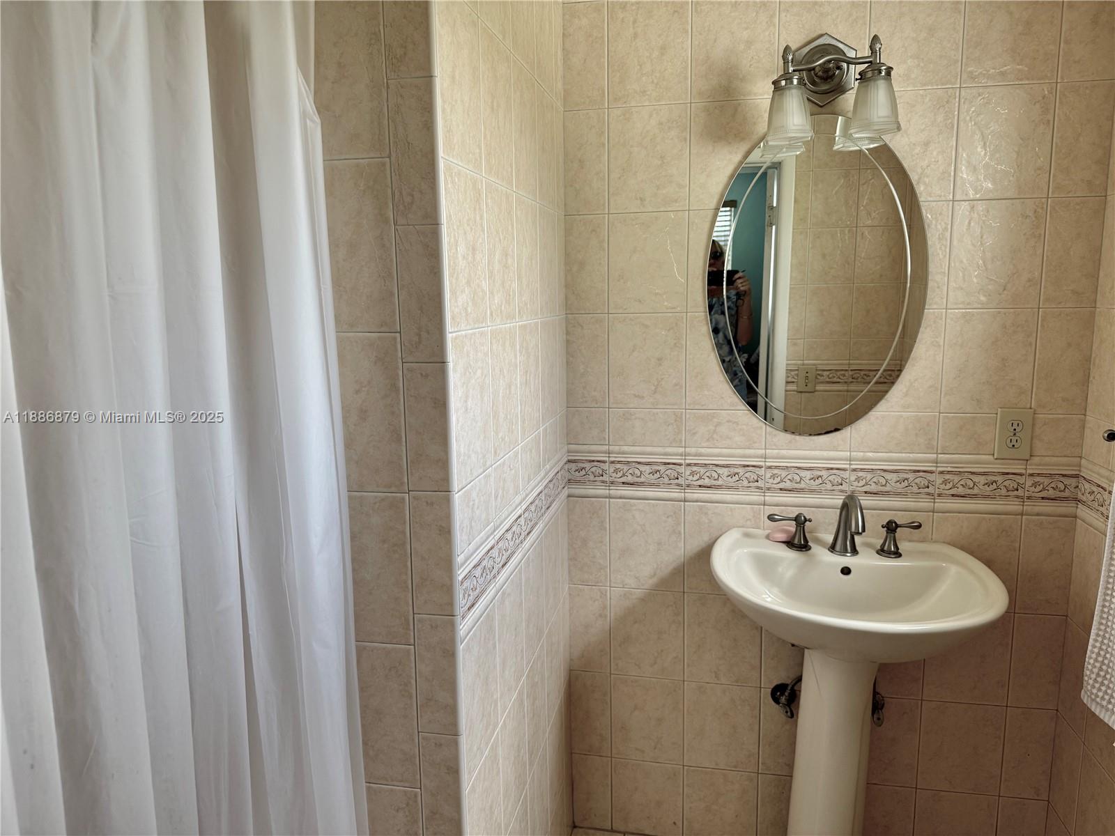 3310 Southwest 94th Place Miami, FL 33165 - Photo 14 of 24 a bathroom with a sink and a mirror
