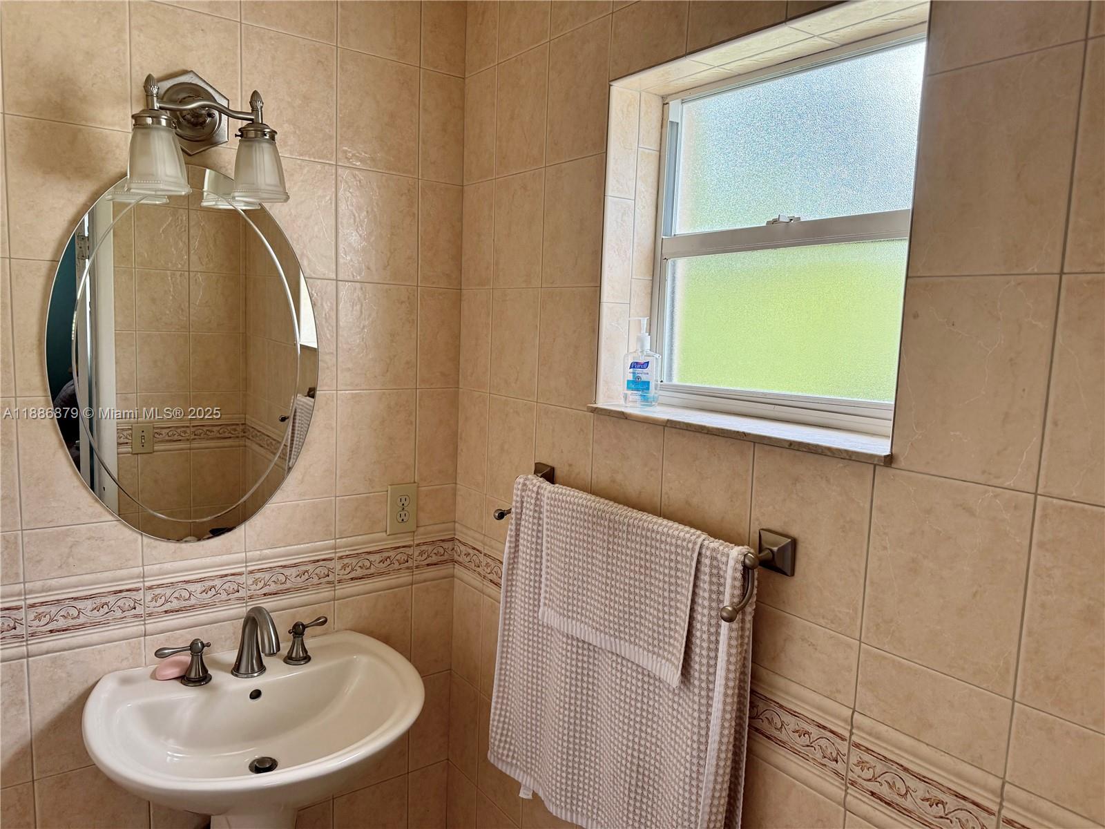 3310 Southwest 94th Place Miami, FL 33165 - Photo 15 of 24 a bathroom with a sink and a mirror