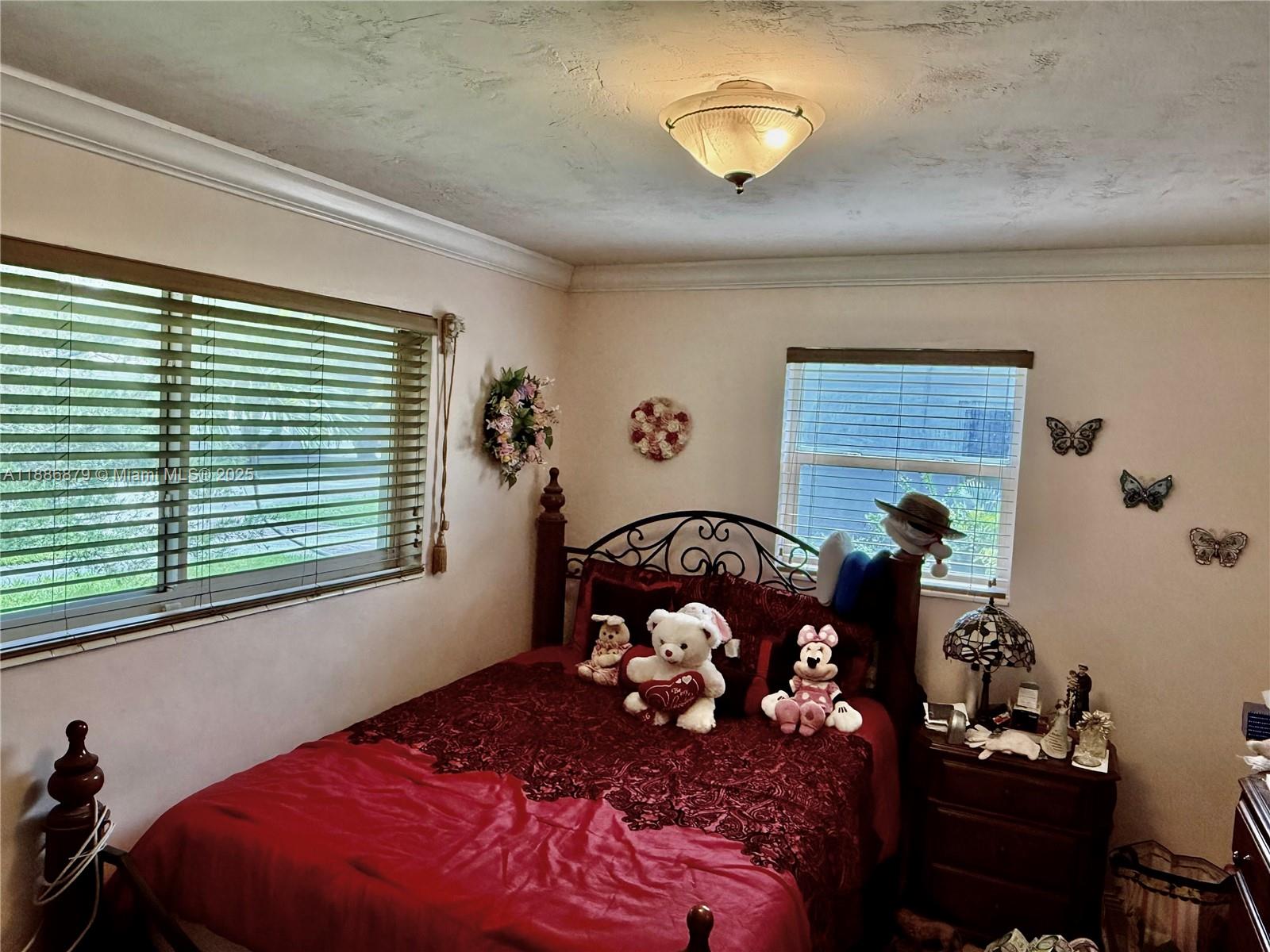 3310 Southwest 94th Place Miami, FL 33165 - Photo 16 of 24 a bedroom with a bed and a window