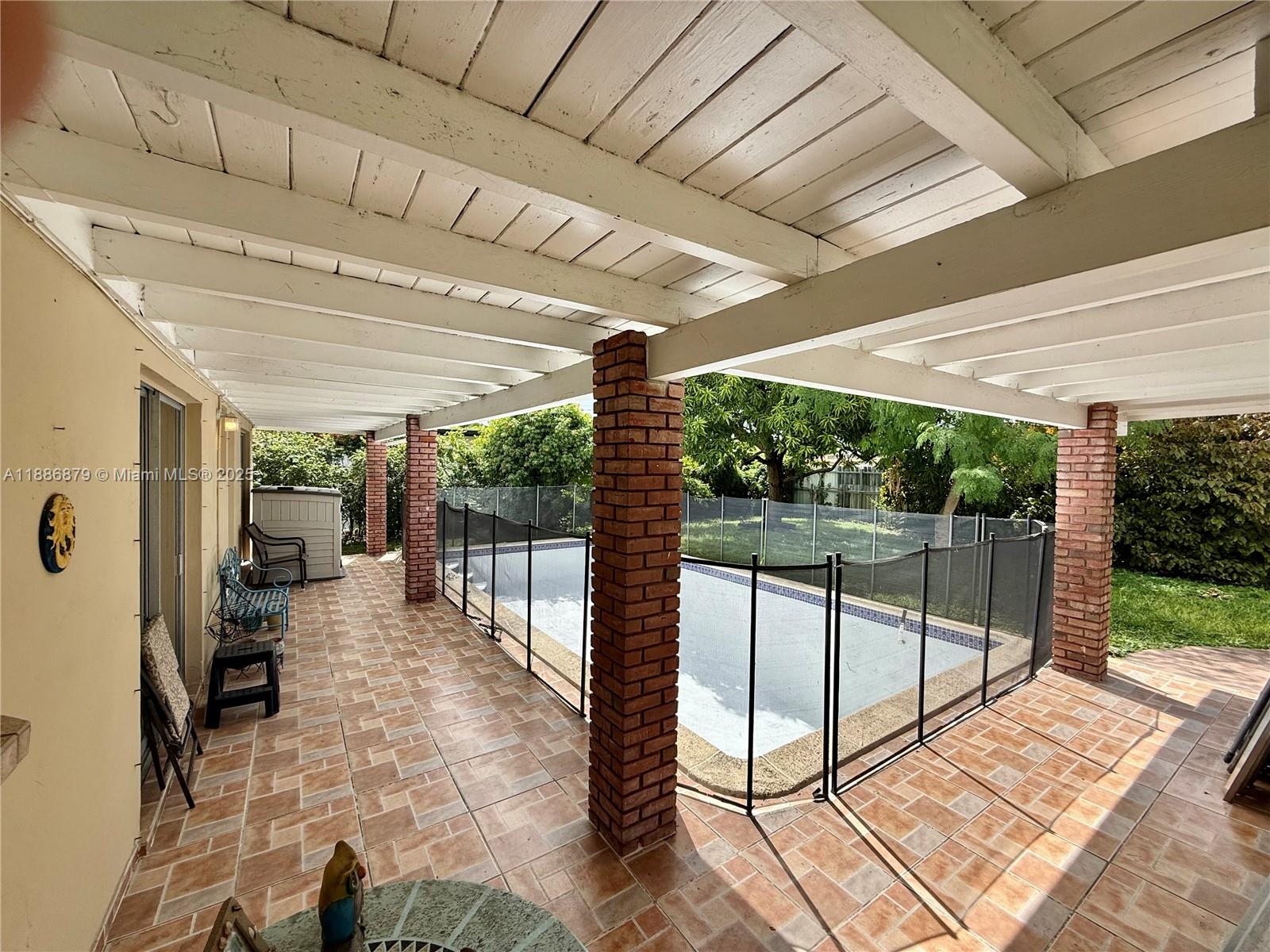 3310 Southwest 94th Place Miami, FL 33165 - Photo 20 of 24 a view of a patio with a table chairs and a patio