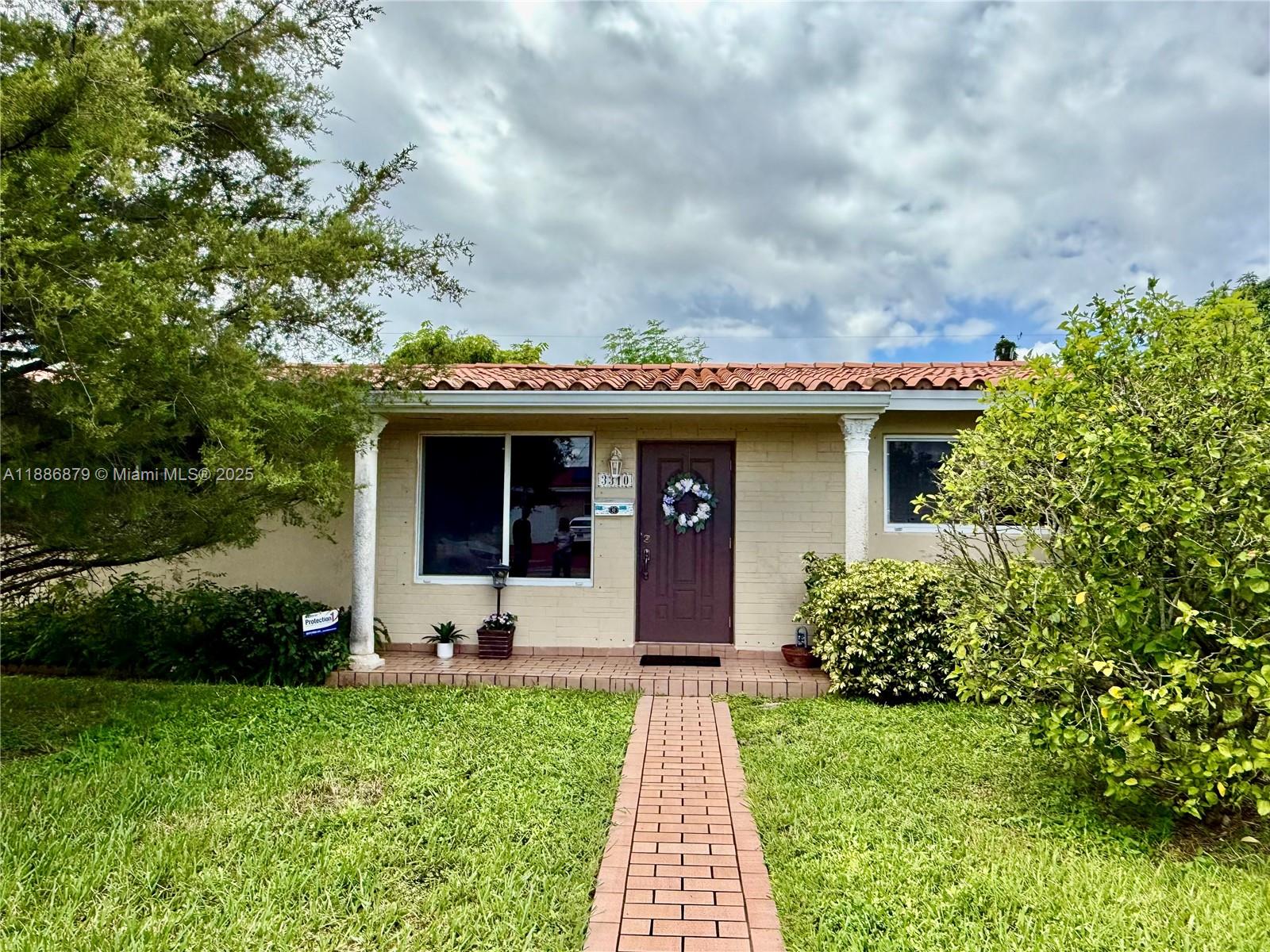 3310 Southwest 94th Place Miami, FL 33165 - Photo 2 of 24 a front view of a house with garden