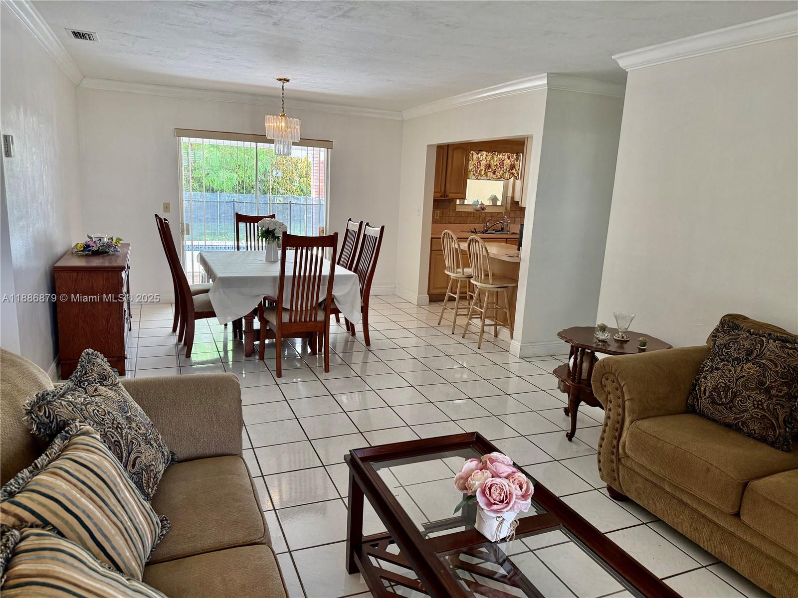 3310 Southwest 94th Place Miami, FL 33165 - Photo 8 of 24 a living room with furniture and a large window