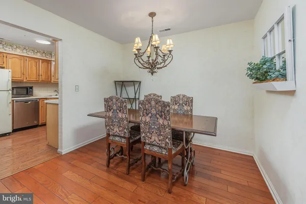 a view of a dining room with furniture wooden floor and chandelier
