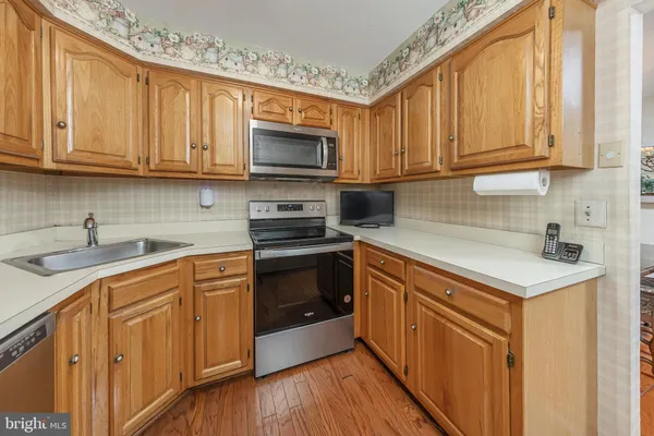 a kitchen with stainless steel appliances granite countertop a sink stove and microwave