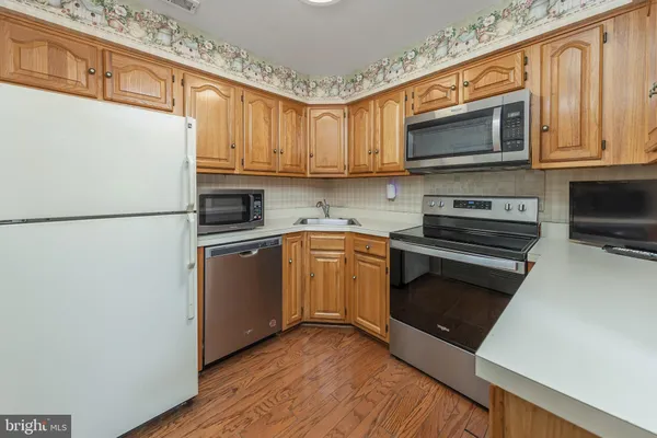 a kitchen with a refrigerator stove and microwave