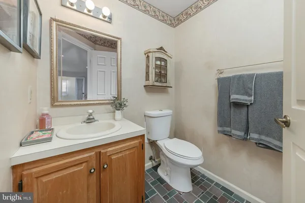 a bathroom with a toilet a sink and mirror