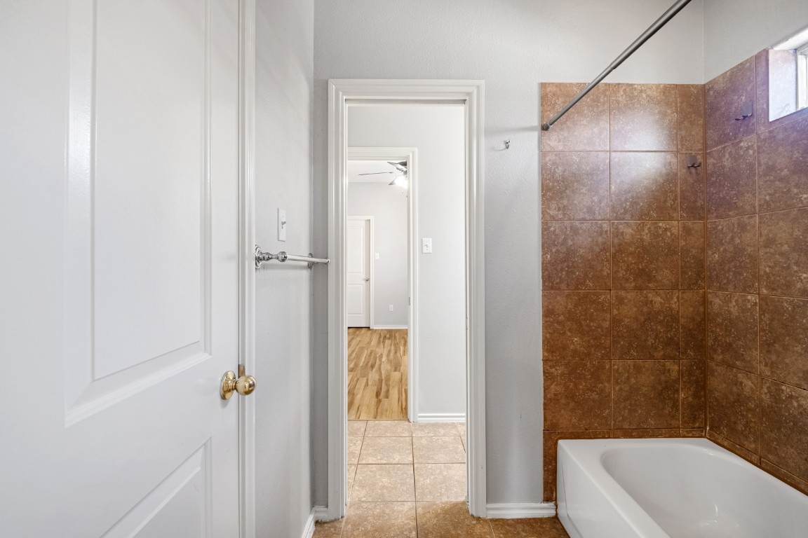2906 Pearl Street, Unit C Austin, TX 78705 - Photo 15 of 25 Full bathroom featuring tub / shower combination, light tile patterned flooring, and ceiling fan