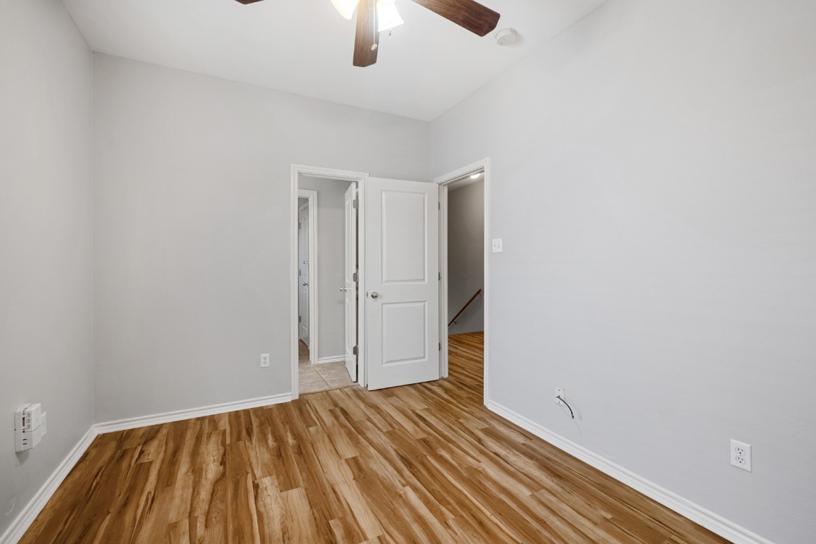 2906 Pearl Street, Unit C Austin, TX 78705 - Photo 18 of 25 Spare room with light wood-type flooring and ceiling fan