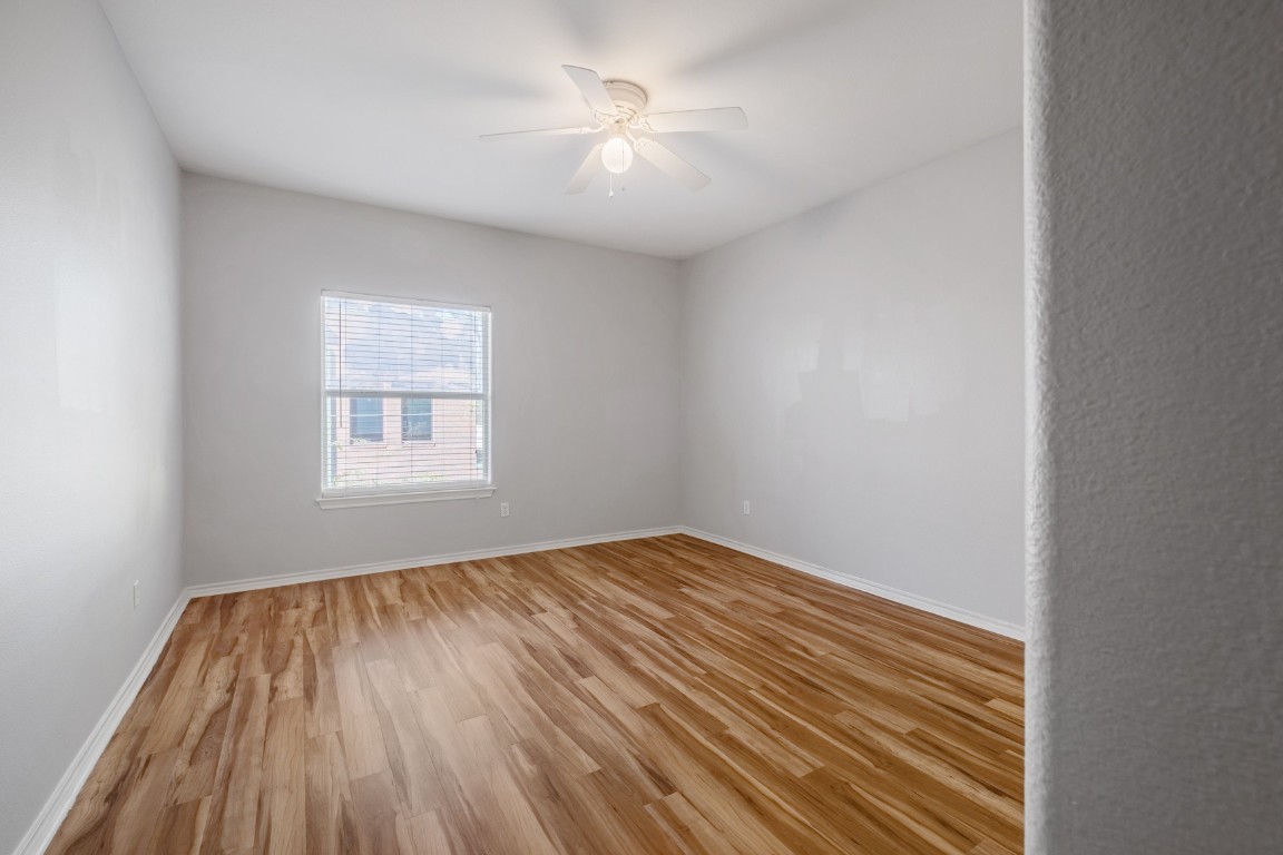 2906 Pearl Street, Unit C Austin, TX 78705 - Photo 19 of 25 Unfurnished room featuring light wood-style floors and ceiling fan