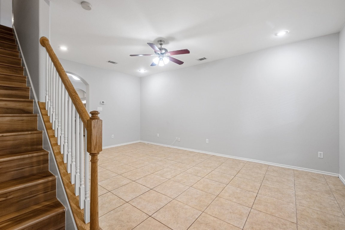 2906 Pearl Street, Unit C Austin, TX 78705 - Photo 2 of 25 Unfurnished room featuring arched walkways, stairs, light tile patterned flooring, ceiling fan, and recessed lighting