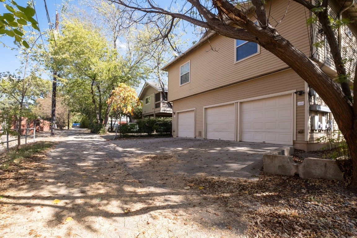 2906 Pearl Street, Unit C Austin, TX 78705 - Photo 25 of 25 View of side of property with an attached garage and driveway