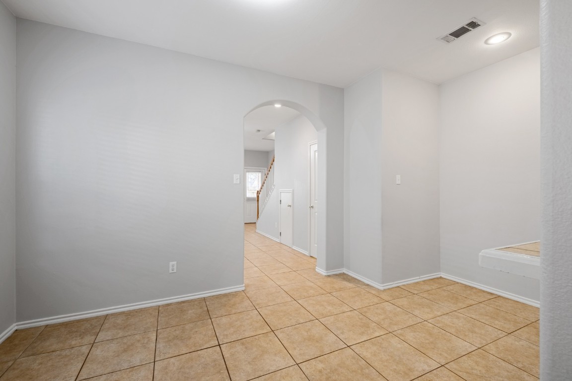 2906 Pearl Street, Unit C Austin, TX 78705 - Photo 5 of 25 Empty room with arched walkways, light tile patterned floors, and recessed lighting