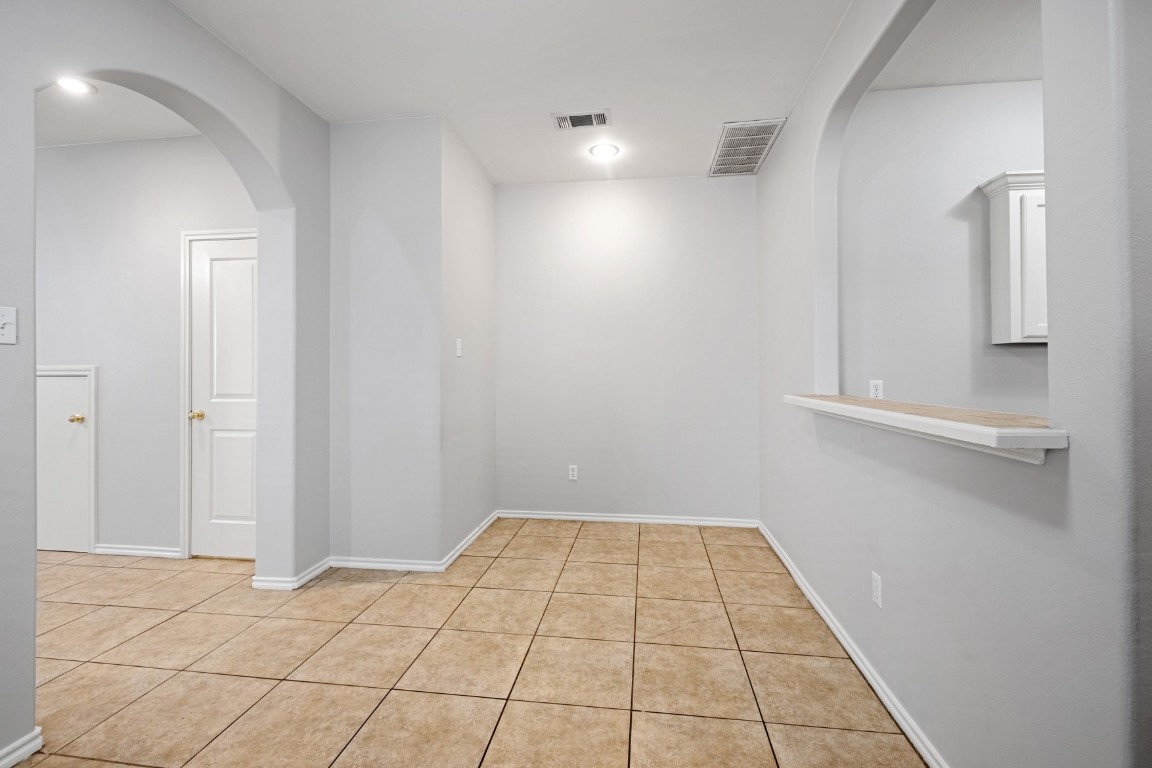 2906 Pearl Street, Unit C Austin, TX 78705 - Photo 6 of 25 Unfurnished room featuring arched walkways and light tile patterned flooring