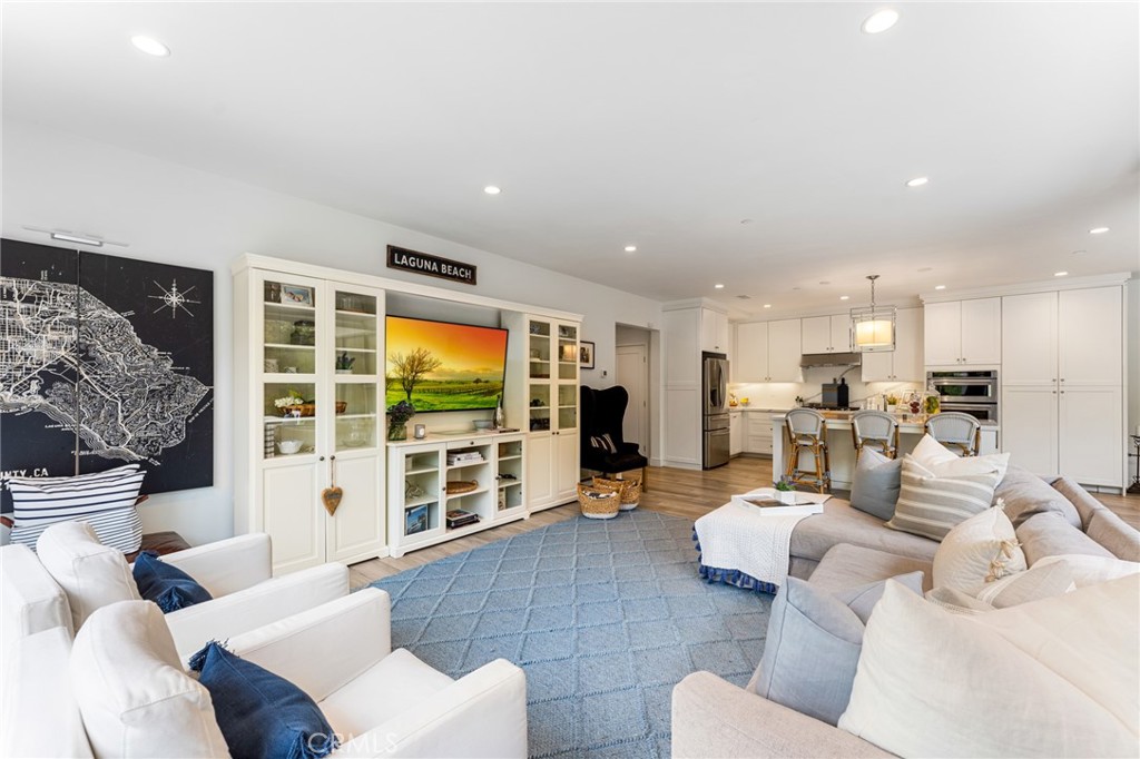 218 Oceano Irvine, CA 92602 - Photo 28 of 56 a living room with furniture a flat screen tv and floor to ceiling window
