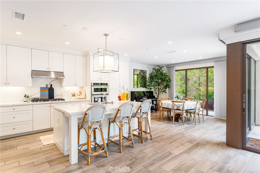218 Oceano Irvine, CA 92602 - Photo 31 of 56 a very nice looking open dining room with kitchen island furniture a rug a fireplace and a window