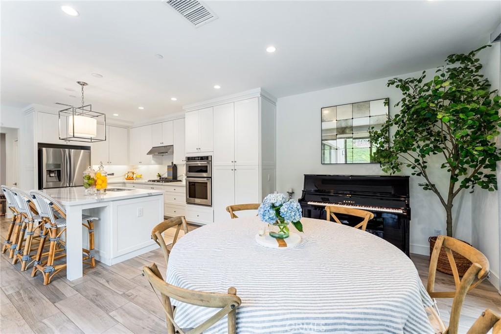 218 Oceano Irvine, CA 92602 - Photo 41 of 56 a kitchen with a table chairs stove and cabinets
