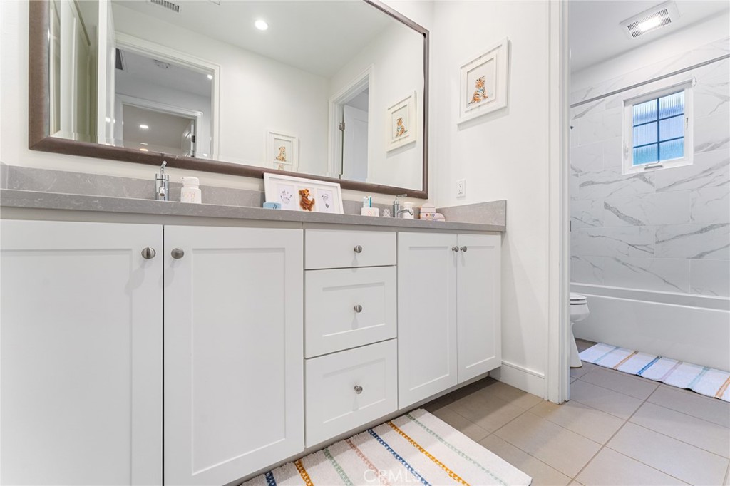 218 Oceano Irvine, CA 92602 - Photo 49 of 56 a bathroom with a granite countertop sink and a mirror