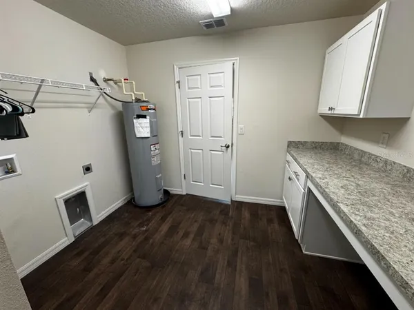 a kitchen with a sink a refrigerator and cabinets