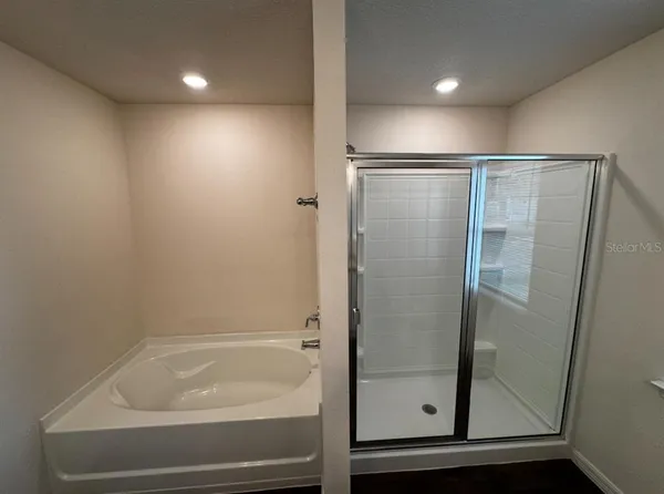 a bathroom with a glass shower door