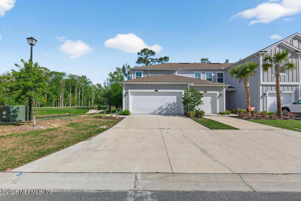 a front view of a house with a yard and a garage