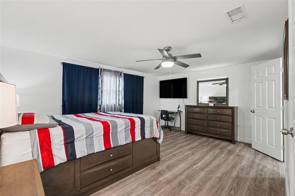 11828 Bingham Drive Port Richey, FL 34668 - Photo 17 of 32 a living room with a bed and furniture