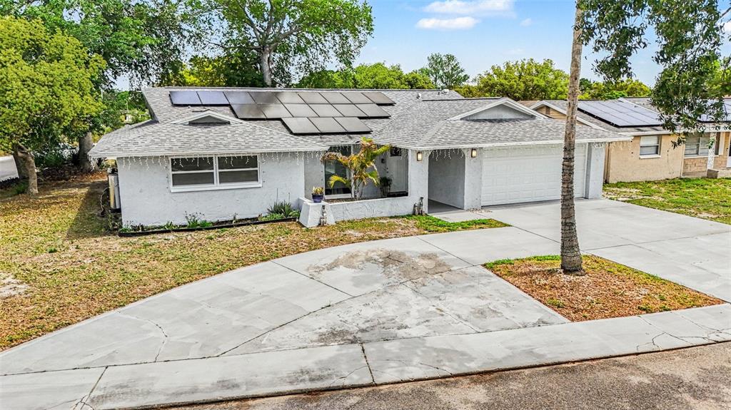 11828 Bingham Drive Port Richey, FL 34668 - Photo 28 of 32 a front view of a house with garden