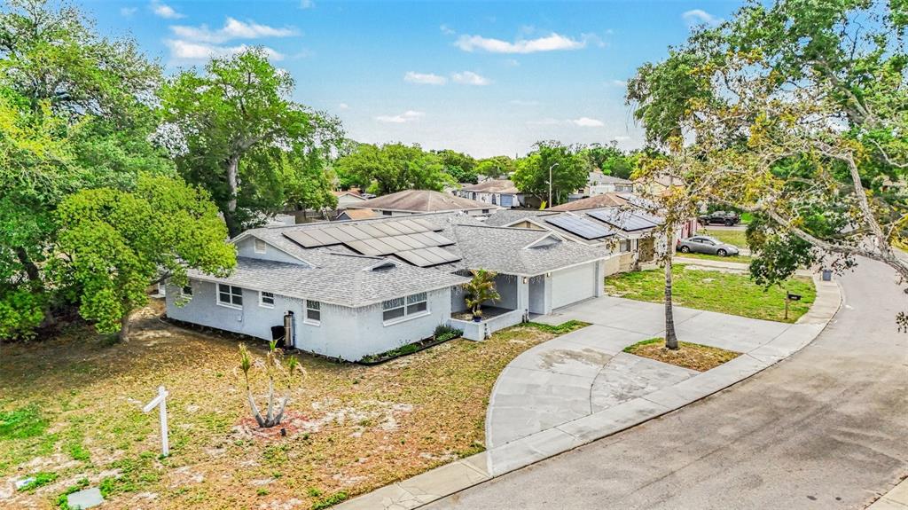 11828 Bingham Drive Port Richey, FL 34668 - Photo 30 of 32 a aerial view of a house with swimming pool and large trees