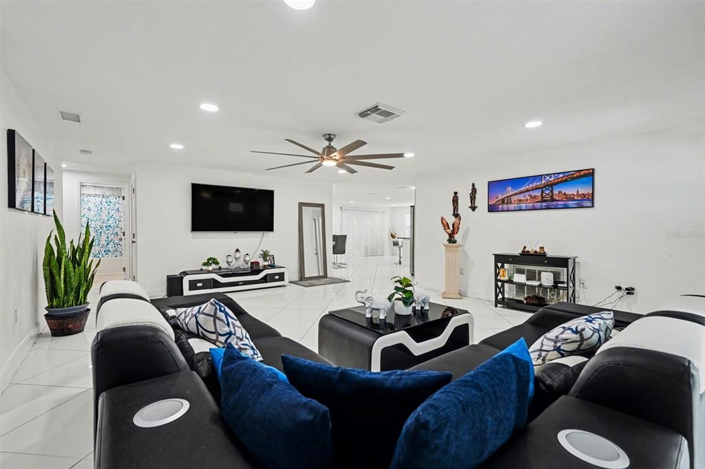 11828 Bingham Drive Port Richey, FL 34668 - Photo 7 of 32 a living room with furniture and a flat screen tv