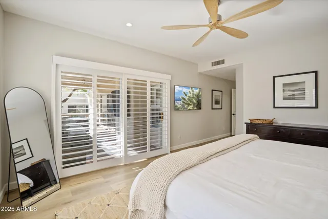 a bedroom with a large bed and a window