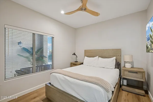 a bedroom with a bed and a window