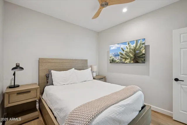 a bedroom with a bed and a painting on the wall