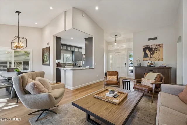 a living room with furniture and a chandelier