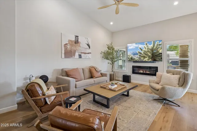 a living room with furniture fireplace and a flat screen tv
