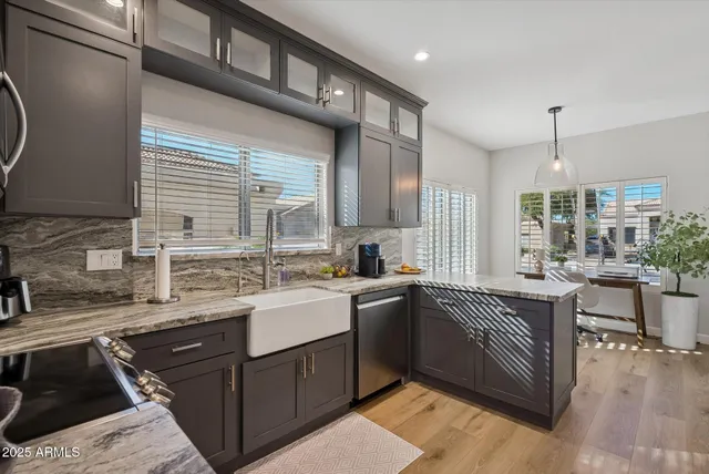 a kitchen with a sink stove and cabinets