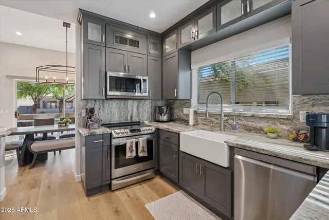 a kitchen with a sink stove and cabinets