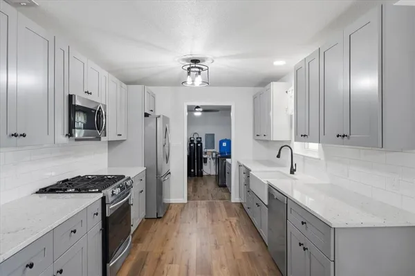 a large kitchen with a stove oven and sink
