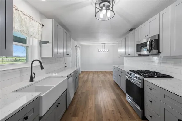 a kitchen with a sink stove and microwave