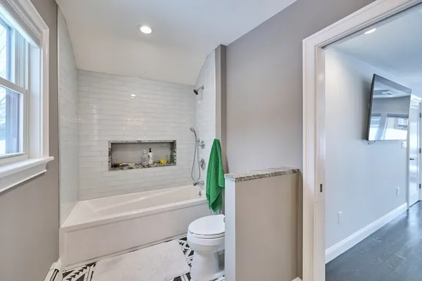 a bathroom with a granite countertop sink mirror and shower