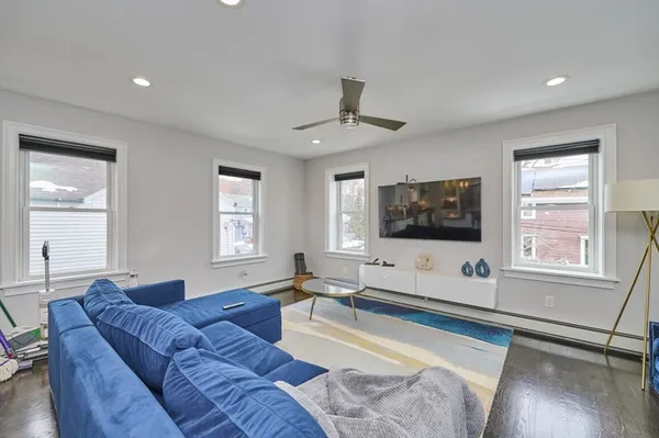 a kitchen with stainless steel appliances granite countertop a sink a stove and a wooden floors