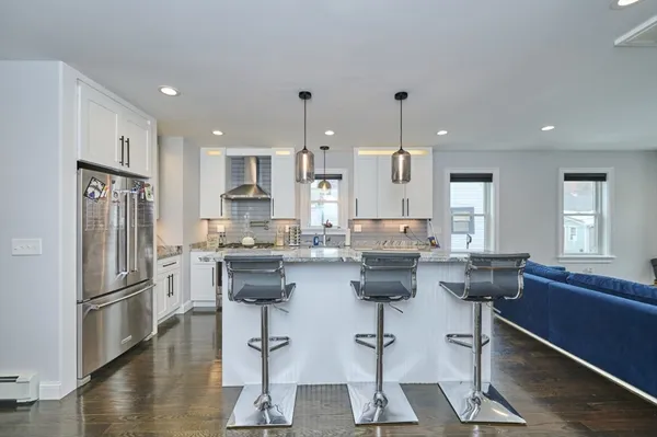 a kitchen with counter top space cabinets and appliances